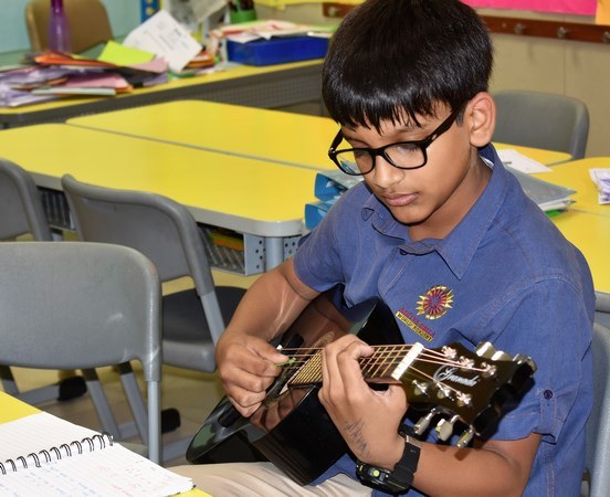 Student playing guitar