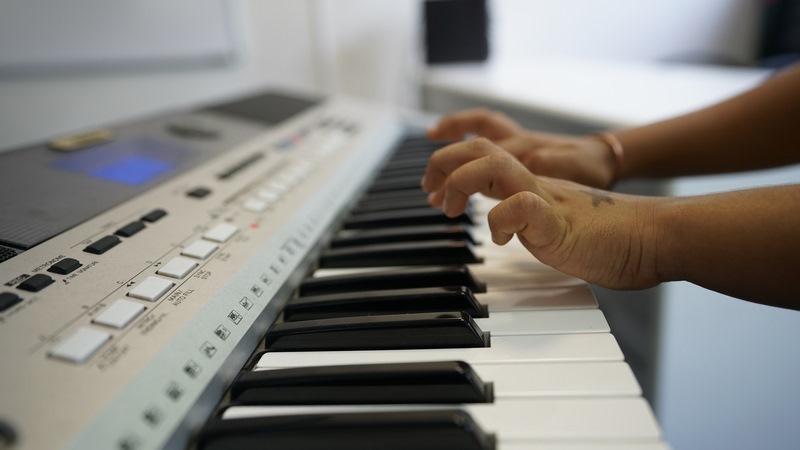 Two little hands playing keyboard